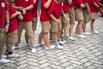 Uniformed children aligned legs