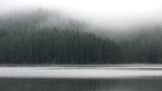Timelapse fog over mountain lake