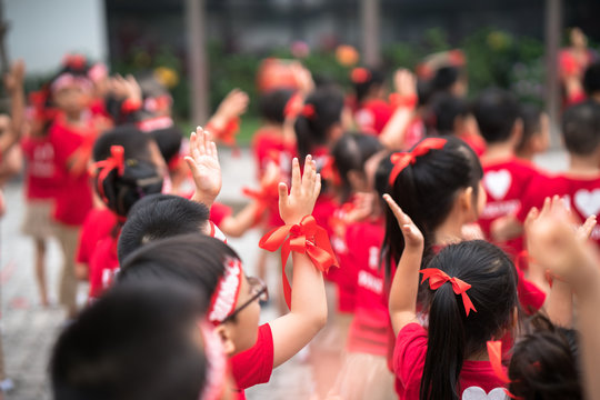 School children raising hands up
