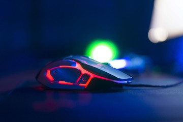 Computer gaming mouse. Professional wire game mouse isolated in the dark.
