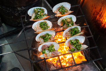 Grilled Oysters on fire with oil, green onion, roasted peanut