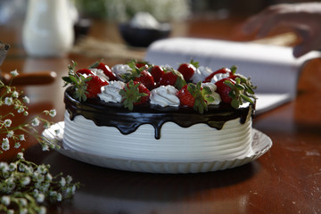 Chocolate cake decorated with fresh strawberries