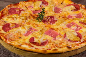 Pizza with ham and sausages