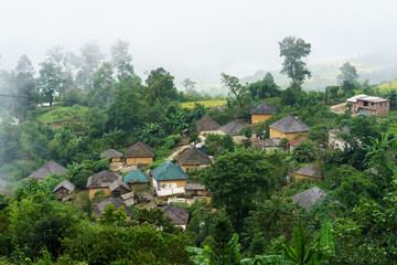 Ethnic minority Ha Nhi village with adobe-style thick-walled houses with mist in Y Ty, Lao Cai province, Vietnam