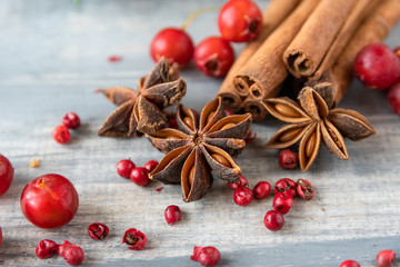 anise seeds, cinnamon sticks and pink pepper - spice  for cooking meats, cakes or mulled wine on wooden table, selective focus and copyspace, Christmas 2019, new year 2019