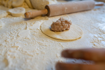Fototapeta na wymiar Making of kibinai - Lithuanian traditional pastry pie with meat.