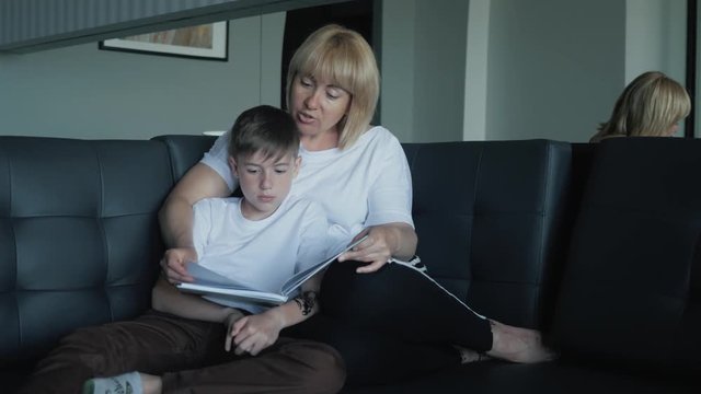 Mom helps my son do homework in the living room. The concept of a happy family
