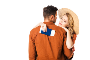 smiling woman with passport and ticket hugging boyfriend isolated on white