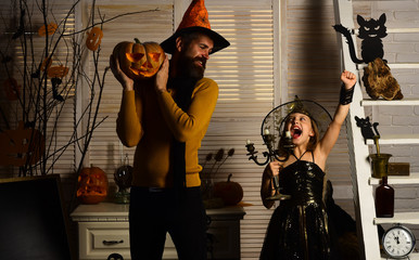 Halloween party concept. Girl and bearded man with winning faces