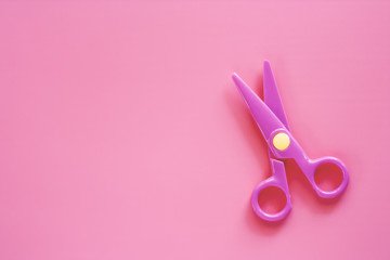 Scissors on pink background with copy space for office and school stationary object