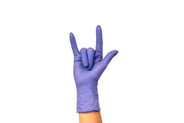 Isolate woman's hand showing two fingers in a lilac rubber glove on a white background. Gesture that rocks or horns. The concept of successful work of a chef of a surgeon or cleaning