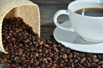 cup of coffee and beans on wooden table
