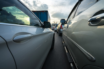 Cars on city street in traffic jam at rush hour