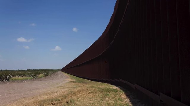 Light Shifting over Border Fence Between USA and Mexico