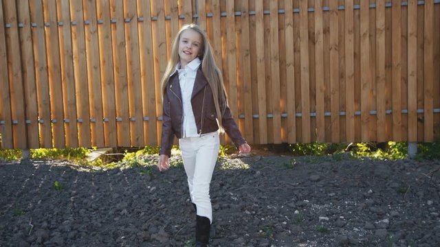 Young pretty girl walks with poses on the manege at camera. 4K
