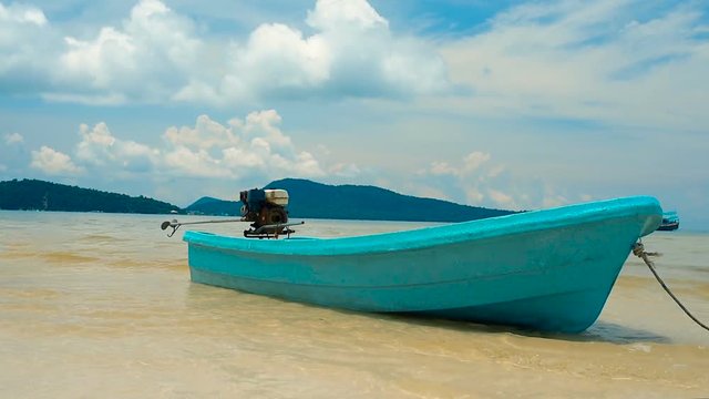 Turquoise fisherman boat moored in Saracen Bay in Koh Ron Samloem, Cambodia. Beautiful paradise beach.