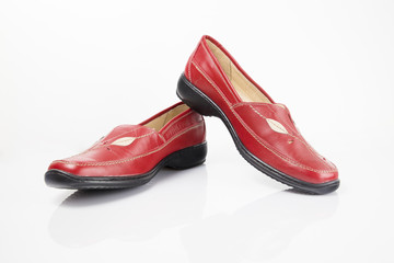 Female red leather shoe on white background, isolated product, comfortable footwear.