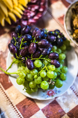 Black and white grape on a plate