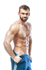 bodybuilder posing. Beautiful sporty guy male power. Fitness muscled in blue shorts. on isolated...