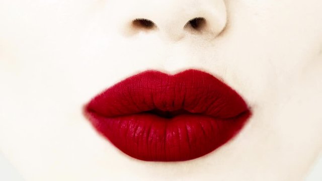 Woman's lip gestures with red lipstick