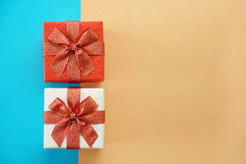 Red and white gift boxes on blur and brown background, picture have space for idea.