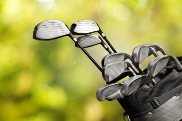 Different golf clubs on  background.