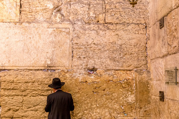 Fototapeta na wymiar Orthodox jewish man prays at Wailing Wall
