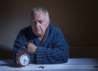 Fed up, tired mature man awake in the middle of the night 