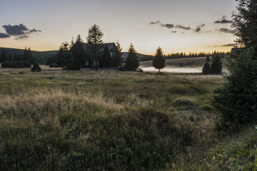 Evening view on the mountain landscape where there are fog above brook. The area "Jizerské hory" hamlet "Jizerka".