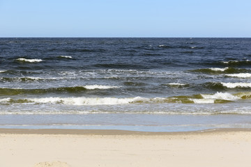 Fototapeta na wymiar Sea waves by the shore in Kolobrzeg