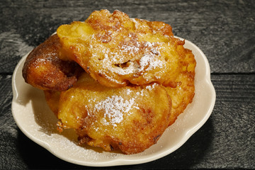 Small homemade doughnuts are sugar-coated