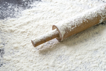 Rolling pin and flour on the kitchen table.