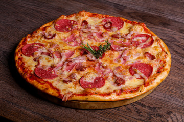Pizza with ham and sausages
