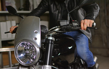 Fototapeta na wymiar Biker on his motorcycle in a garage