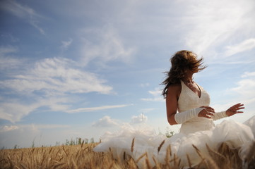 Mysterious bride lost somewere in a grain field