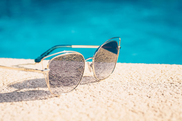 sunglasses lying around pool - tropical vacation