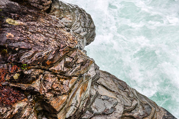 The Texture of Warn Rock Along a Fast Moving Stream in Montana's Glacier National Park