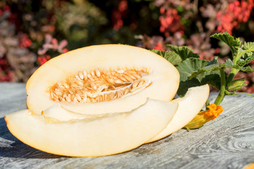 Sliced melon on wooden table outdoors