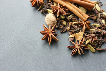 Various Spices background. Cinnamon sticks and anise stars close-up on wood background. Copy space