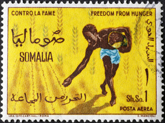 Farmer sowing on somali postage stamp