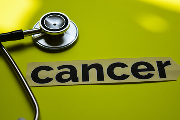 Closeup cancer with stethoscope concept inspiration on yellow background