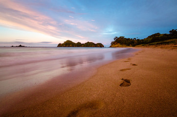 footprints at beach, sunset