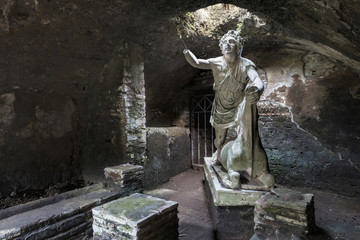 Fototapeta premium Statue of the god Mithras killing a bull in the thermal s mithraeum in archaeological excavations of Antica Ostia