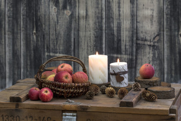 Fototapeta na wymiar Rustic Christmas still life with candles on old wooden crate