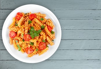 Pasta fusilli with bolognese tomato beef sauce on the kitchen
