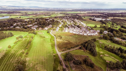 Aerial view over the village of Bridge of Weir and surrounding countryside.