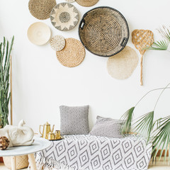 Modern minimal home interior design. Pillows, golden teapot, decorative straw plates, Scandinavian...