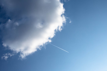 Naklejka na ściany i meble airplane and cloud in the blue sky
