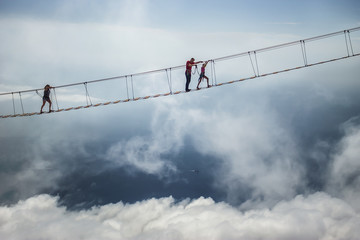 Tourist walking on rope bridge on the Mount Ai-Petri, Crimea