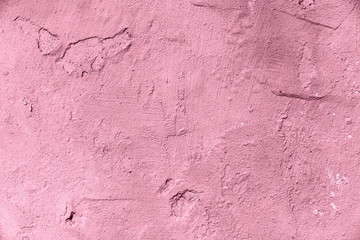 Different colors on the cracked wall.The paint is old on the wall. The texture of the wall.